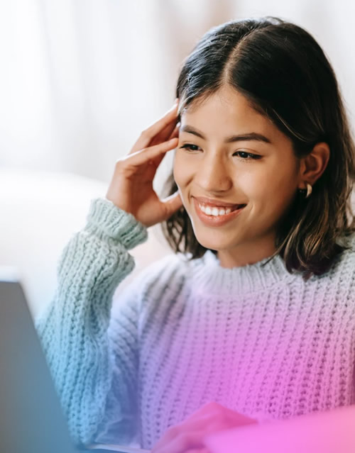 Smiling woman looking at her computer.